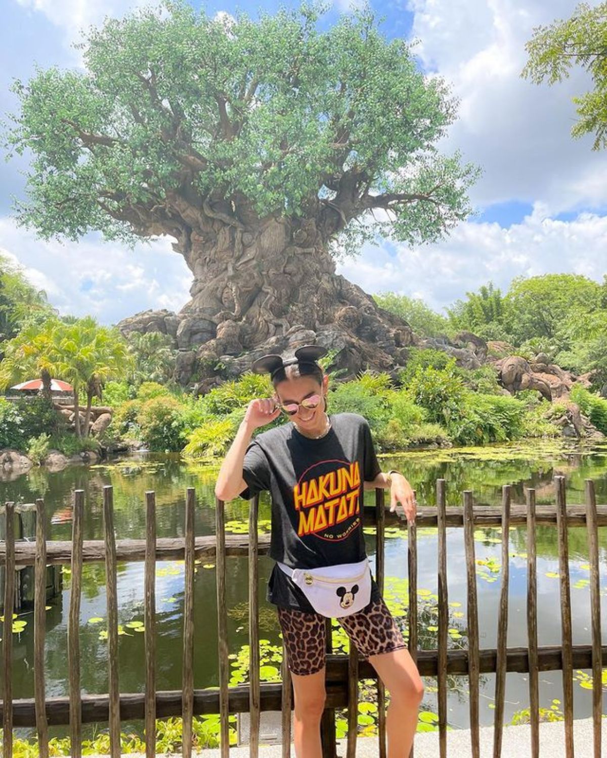 summer outfit with mickey ears, hakuna matata shirt, leopard biker shorts, and mickey mouse fanny pack