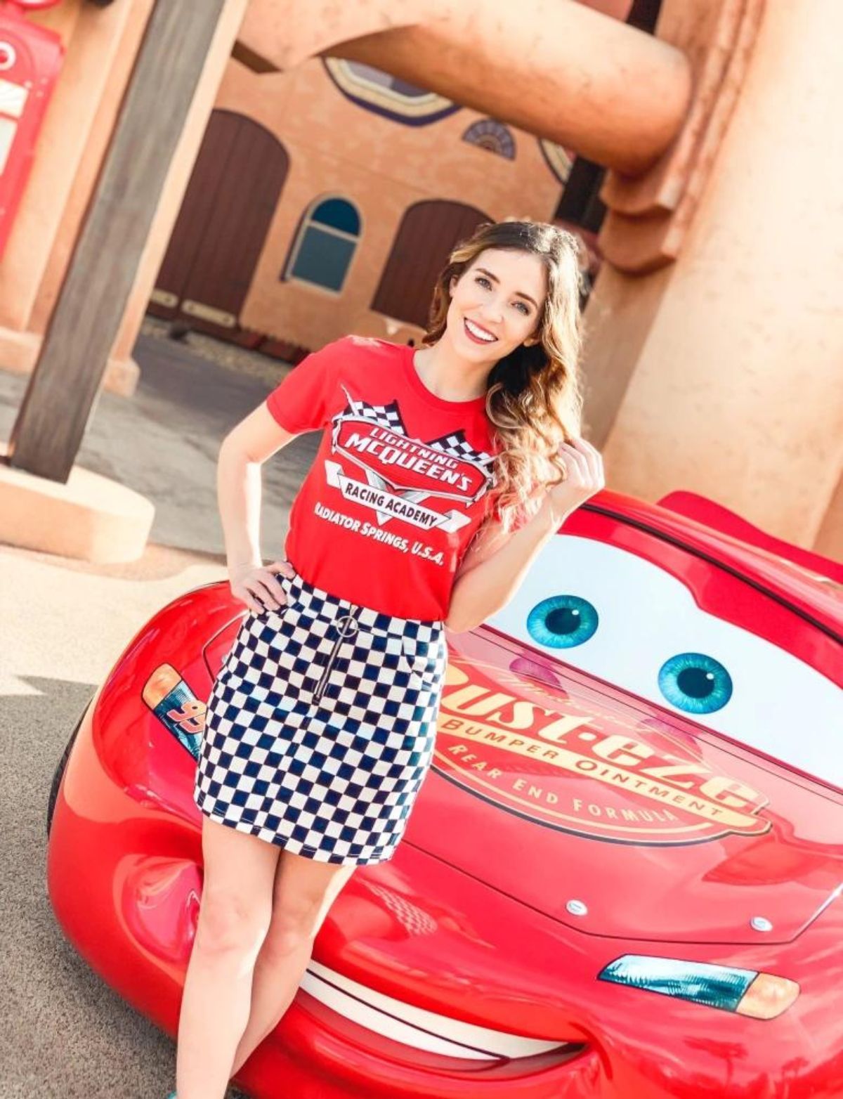 outfit with red lightning mcqueen shirt, and black and white checkered skirt