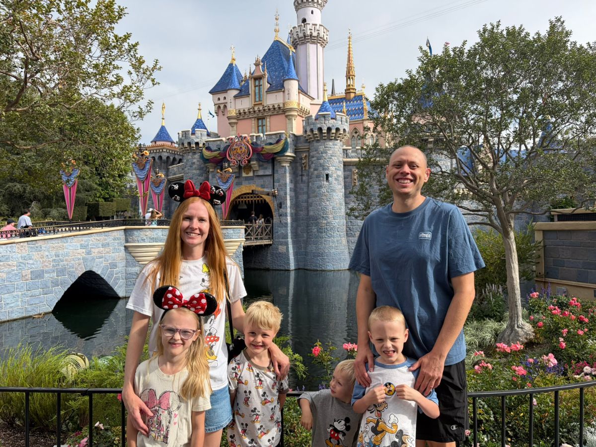 that disney fam in front of Sleeping Beauty Castle in Disneyland Park